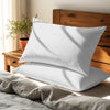White housewife pillowcases cotton percale on pillows on bed in bedroom