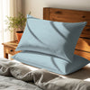 Sea foam housewife pillowcases cotton percale on pillows on bed in bedroom