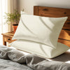 Ivory housewife pillowcases cotton percale on pillows on bed in bedroom