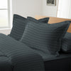 Anthracite stripe oxford king pillowcases deluxe 600 thread count on pillows on bed in bedroom
