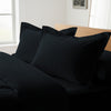 Black oxford king pillowcases deluxe 600 thread count on pillows on bed in bedroom