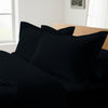 Black oxford standard pillowcases royal 1000 thread count on pillows on bed in bedroom