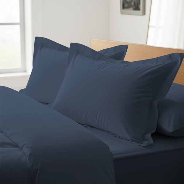 Dark blue oxford king pillowcases royal 1000 thread count on pillows on bed in bedroom
