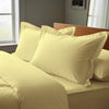 Mellow yellow oxford king pillowcases deluxe 600 thread count on pillows on bed in bedroom