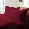 rio red oxford standard pillowcases premium 400 thread count on pillows on bed in bedroom