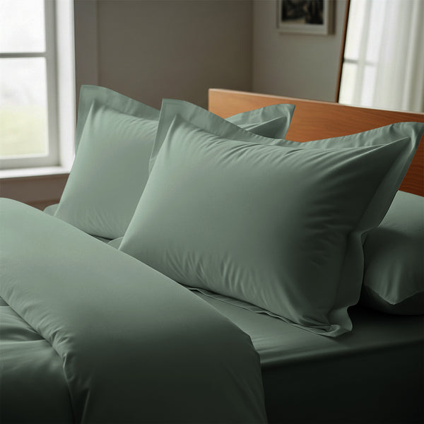 Sea foam oxford standard pillowcases luxurious 800 thread count on pillows on bed in bedroom