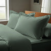Sea foam oxford standard pillowcases royal 1000 thread count on pillows on bed in bedroom
