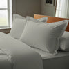 Silver oxford standard pillowcases deluxe 600 thread count on pillows on bed in bedroom