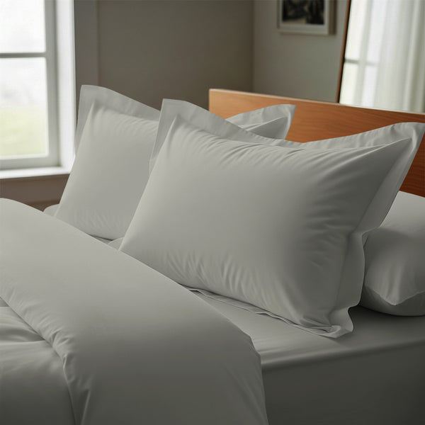 Silver oxford standard pillowcases deluxe 600 thread count on pillows on bed in bedroom