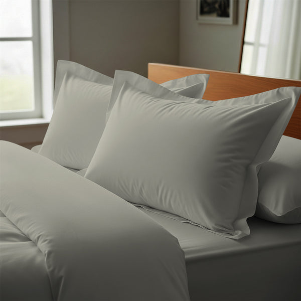 silver oxford standard pillowcases premium 400 thread count on pillows on bed in bedroom