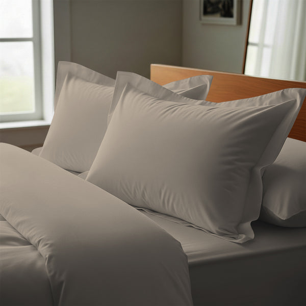 Simply taupe oxford king pillowcases deluxe 600 thread count on pillows on bed in bedroom