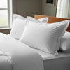 White oxford standard pillowcases royal 1000 thread count on pillows on bed in bedroom