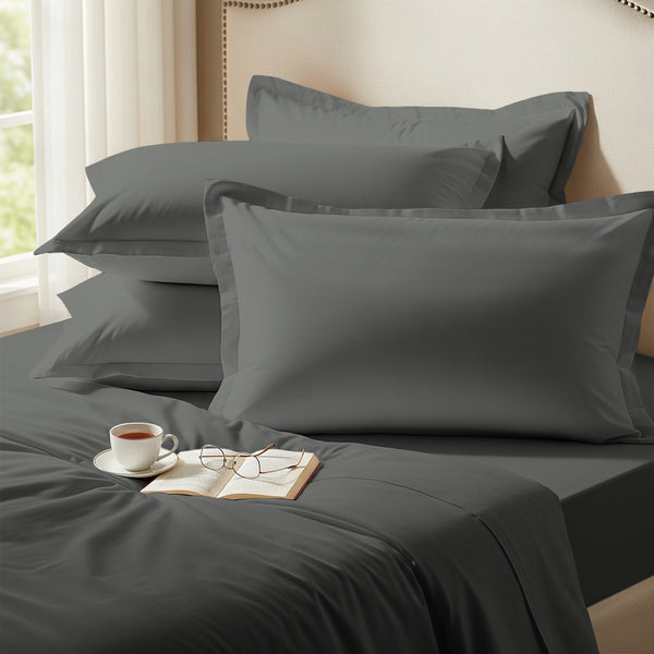 Dark grey oxford standard pillowcases premium 400 thread count on pillows on bed in bedroom