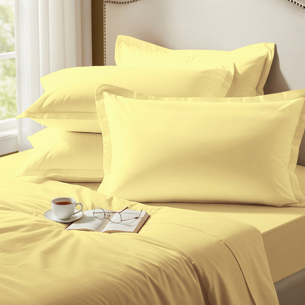 Mellow yellow oxford standard pillowcases premium 400 thread count on pillows on bed in bedroom