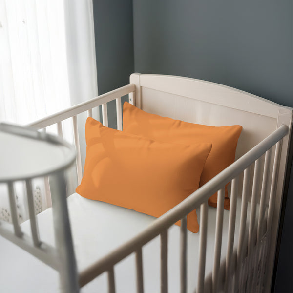 Toddler bed with apricot orange 40 x 60 cm cotton pillowcase on the pillow