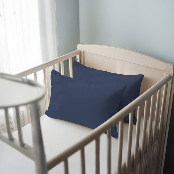 Toddler bed with dark blue 40 x 60 cm cotton pillowcase on the pillow