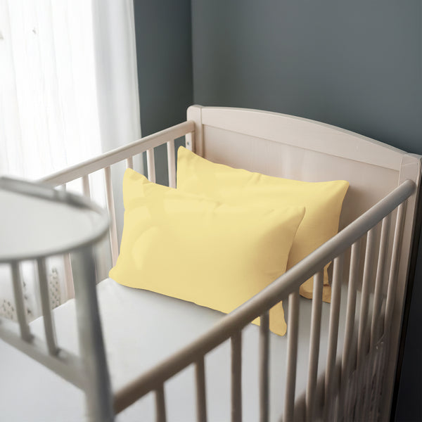 Toddler bed with mellow yellow 33 x 46 cm cotton pillowcase on the pillow