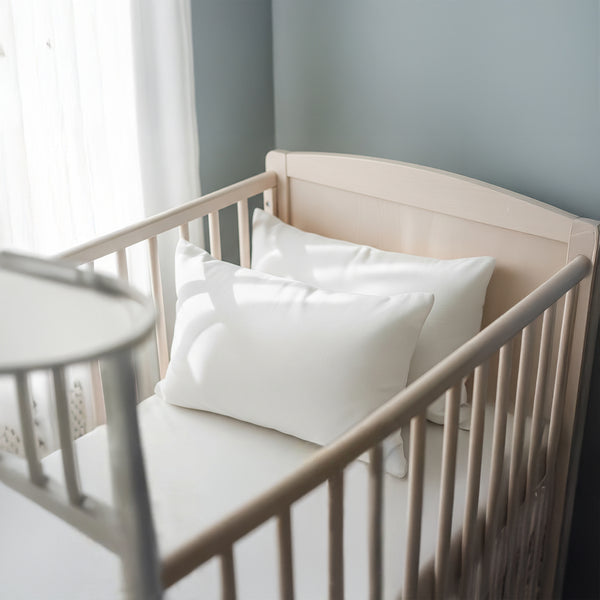 Toddler bed with white 40 x 60 cm cotton pillowcase on the pillow