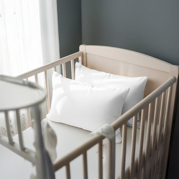 Toddler bed with white 33 x 46 cm cotton pillowcase on the pillow