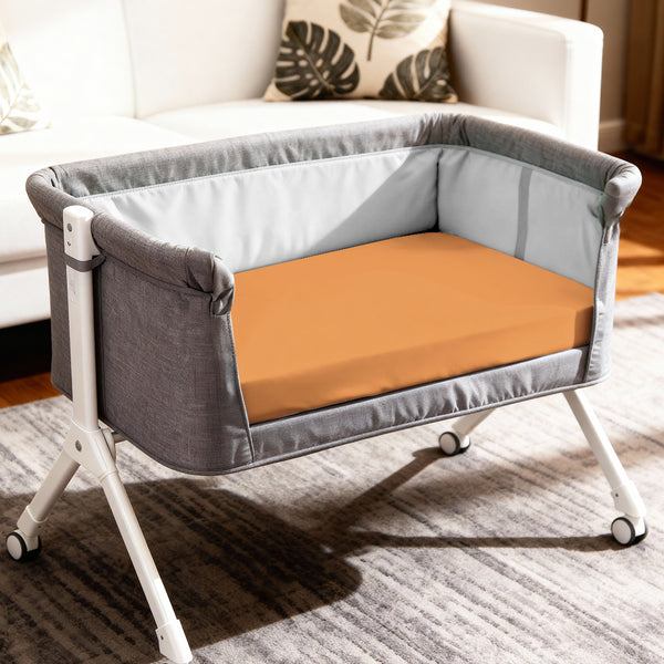 Baby cot setup with 60x120 cm apricot orange travel fitted sheet moisture wicking and gentle on skin