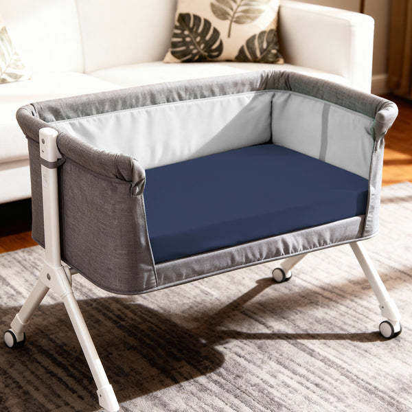 Baby cot setup with 60x120 cm dark blue travel fitted sheet moisture wicking and gentle on skin