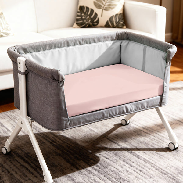 Baby cot setup with 60x120 cm light pink travel fitted sheet moisture wicking and gentle on skin